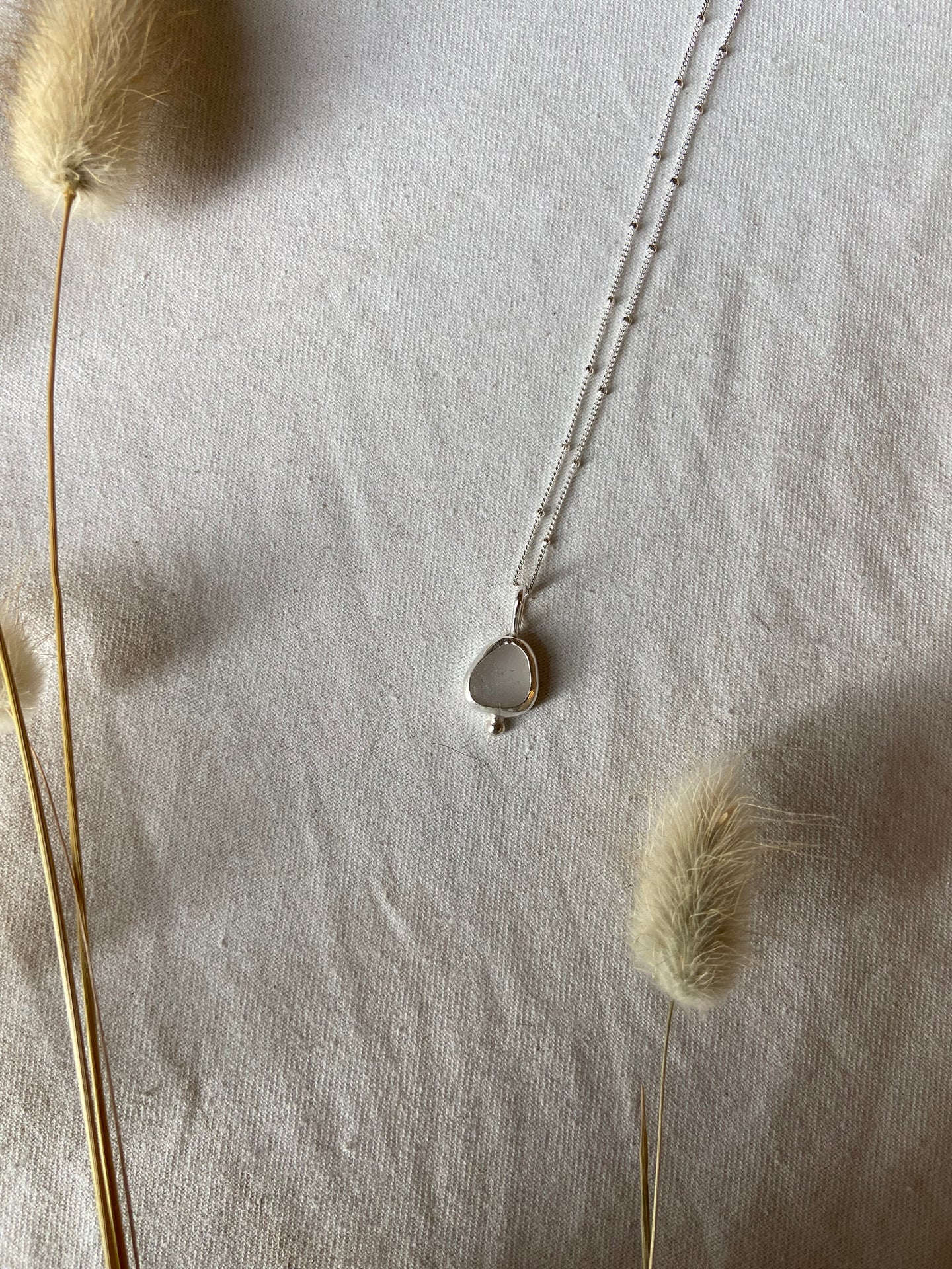 White seaglass pendant with silver granulation