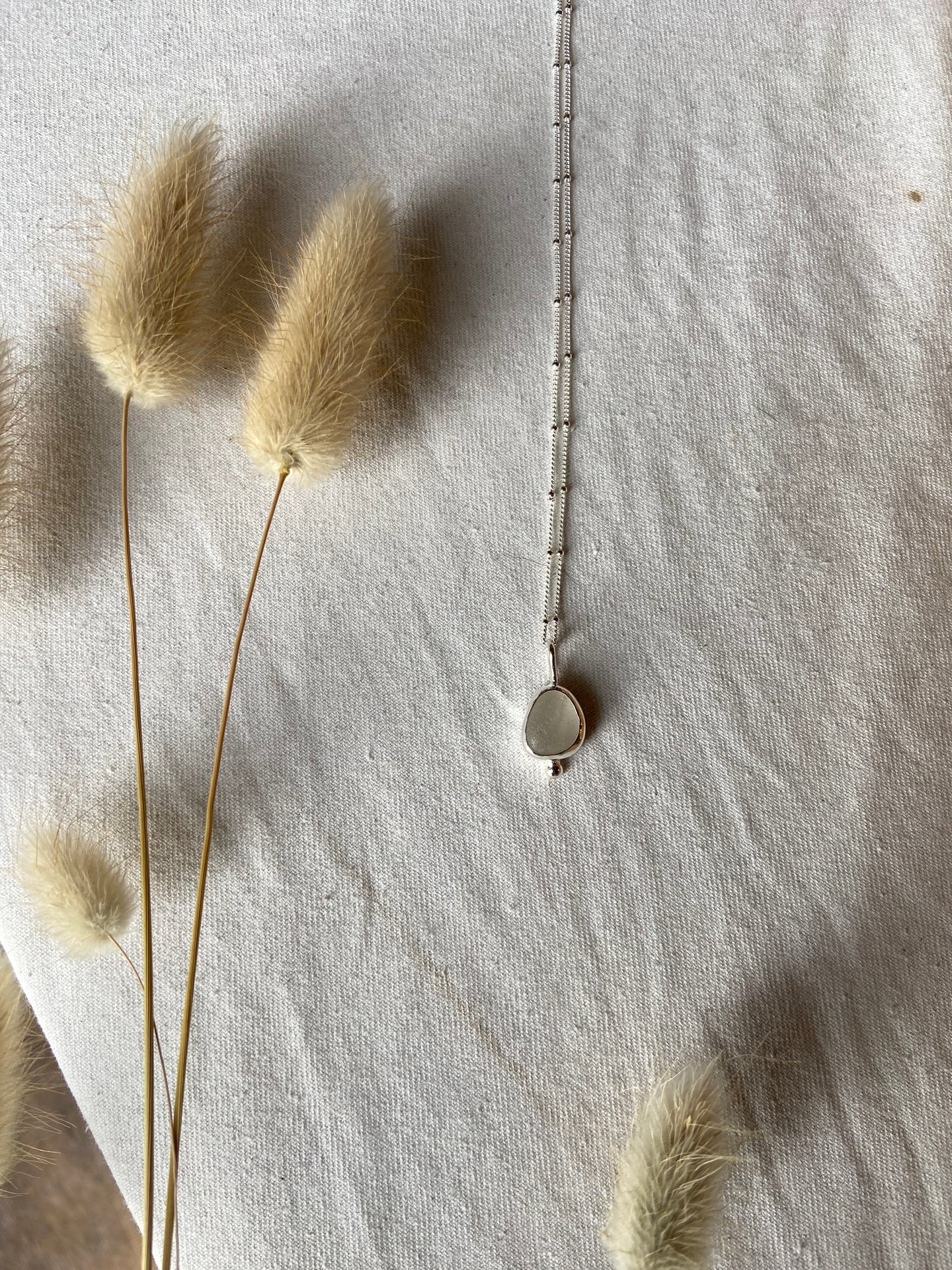 White seaglass pendant with silver granulation detail